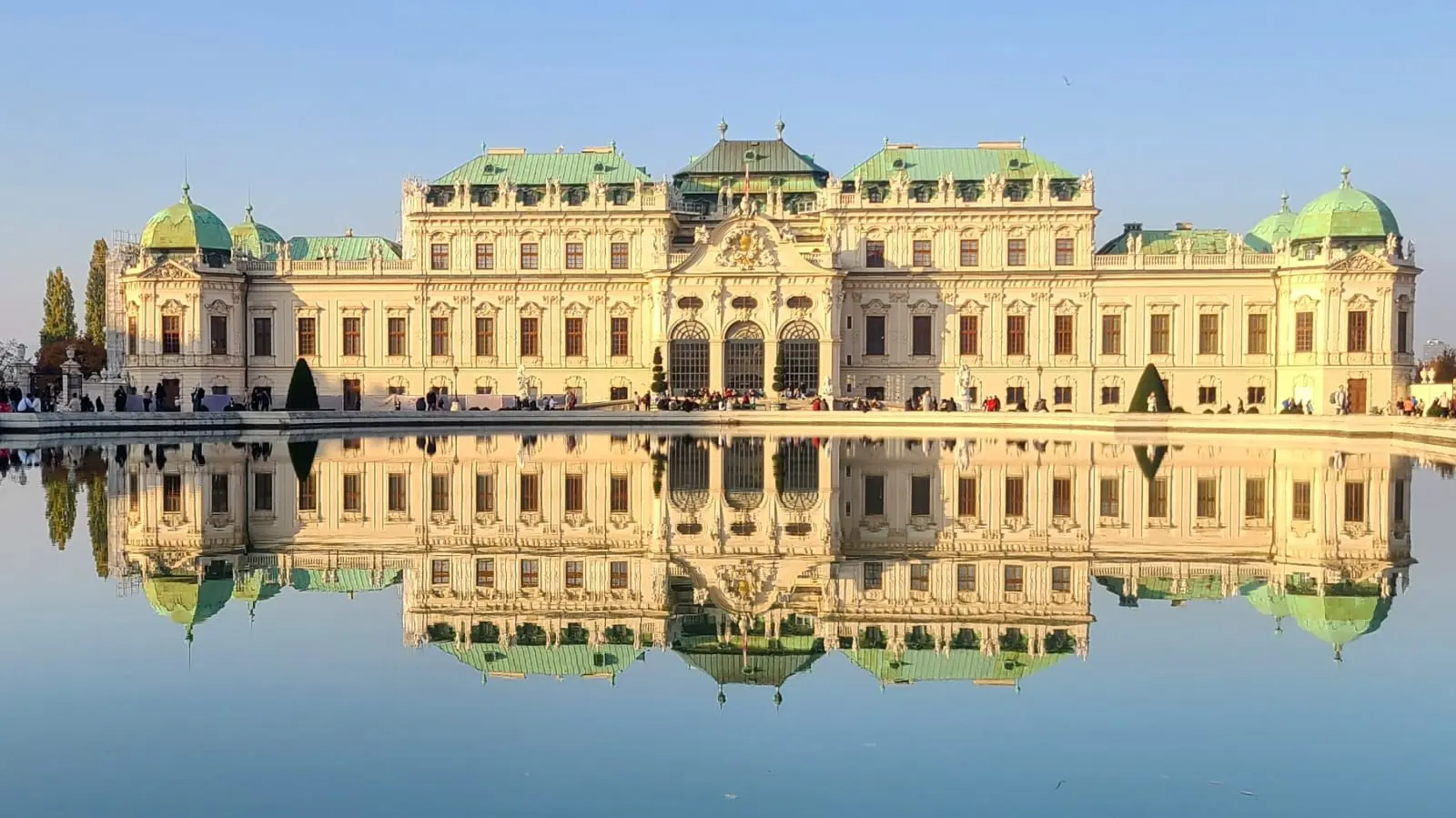 A large building with many windows and green roof
