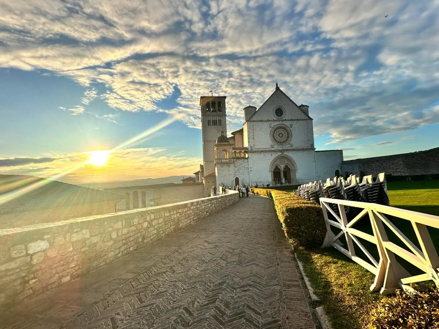 A view of the sun setting over a church.