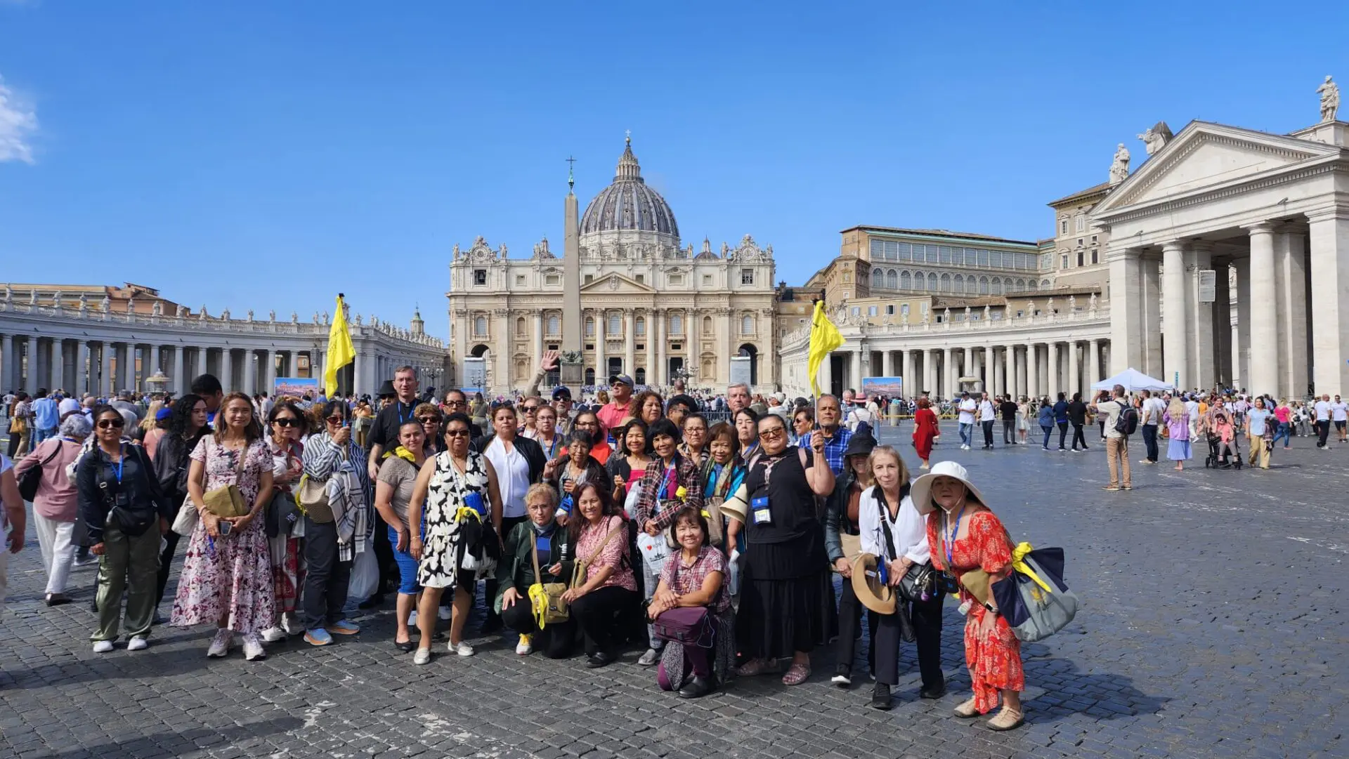 A group of people standing in front of the vatican.